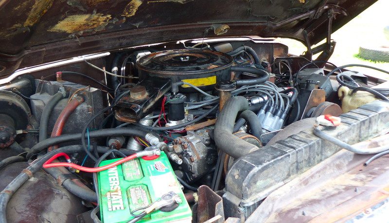 The SJ Cherokee’s carbureted AMC V8.